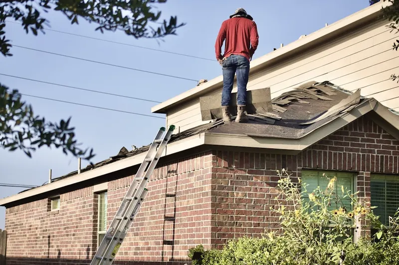 Professional roofer working on a residential roof in Herald